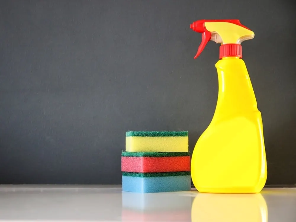 Spray bottle and cleaning sponges on a counter (stock photo)
