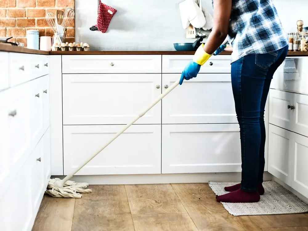 Wiping down a kitchen surface (stock photo)